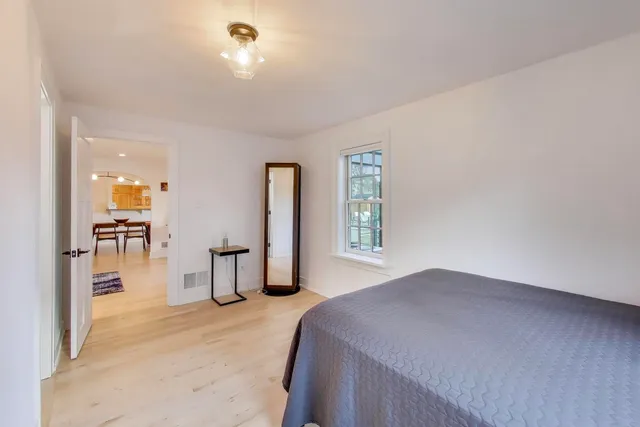 a spacious bedroom with a bed and a window