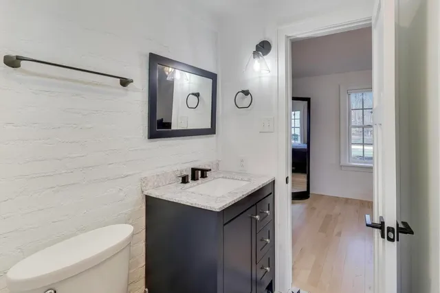 a bathroom with a toilet sink and mirror