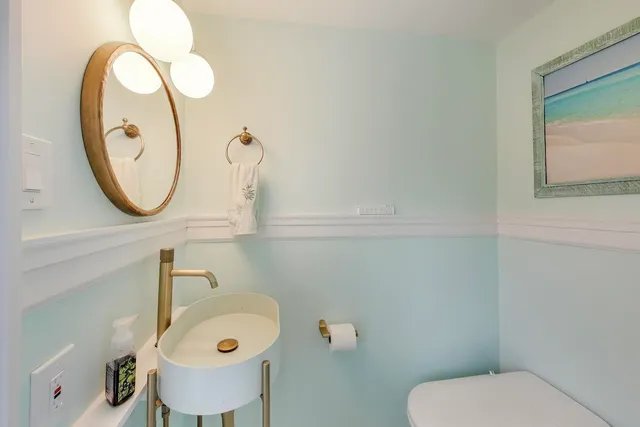 a bathroom with a toilet and a mirror