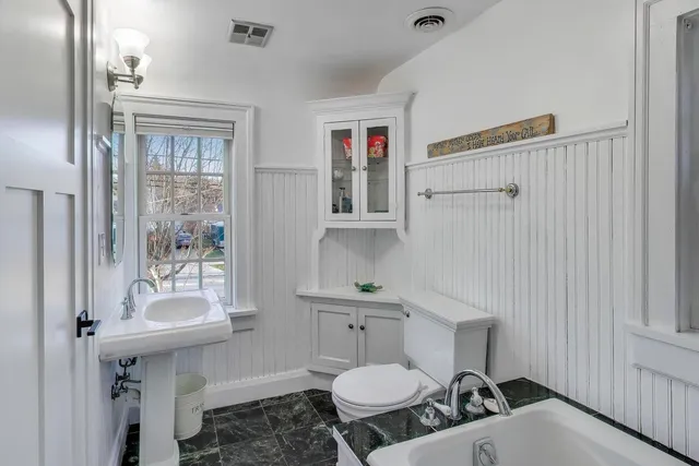 a view of a hallway with wooden floor and entryway