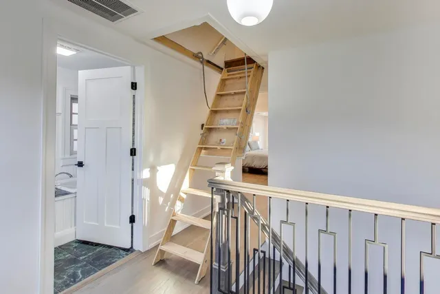 a view of empty room with wooden floor and fireplace