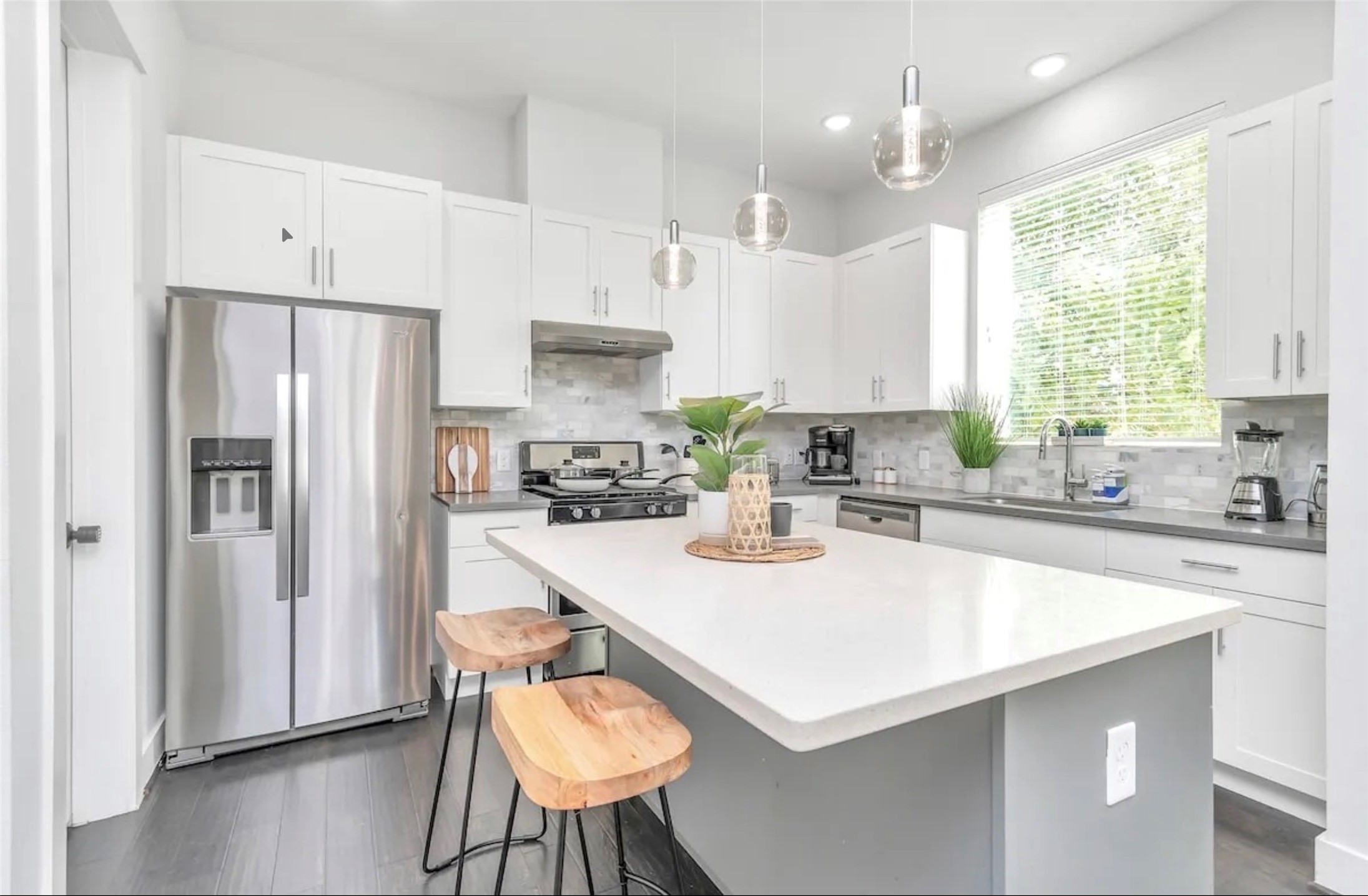 2817 Palm Street Houston, TX 77004 - Photo 12 of 18 a kitchen with stainless steel appliances granite countertop a sink a stove a refrigerator and island with wooden floor