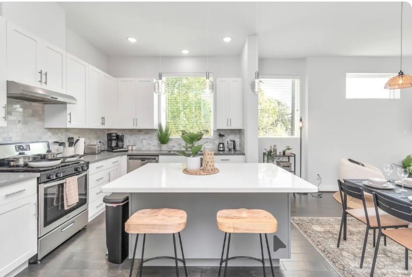 2817 Palm Street Houston, TX 77004 - Photo 2 of 18 a kitchen with stainless steel appliances granite countertop a table chairs stove and sink
