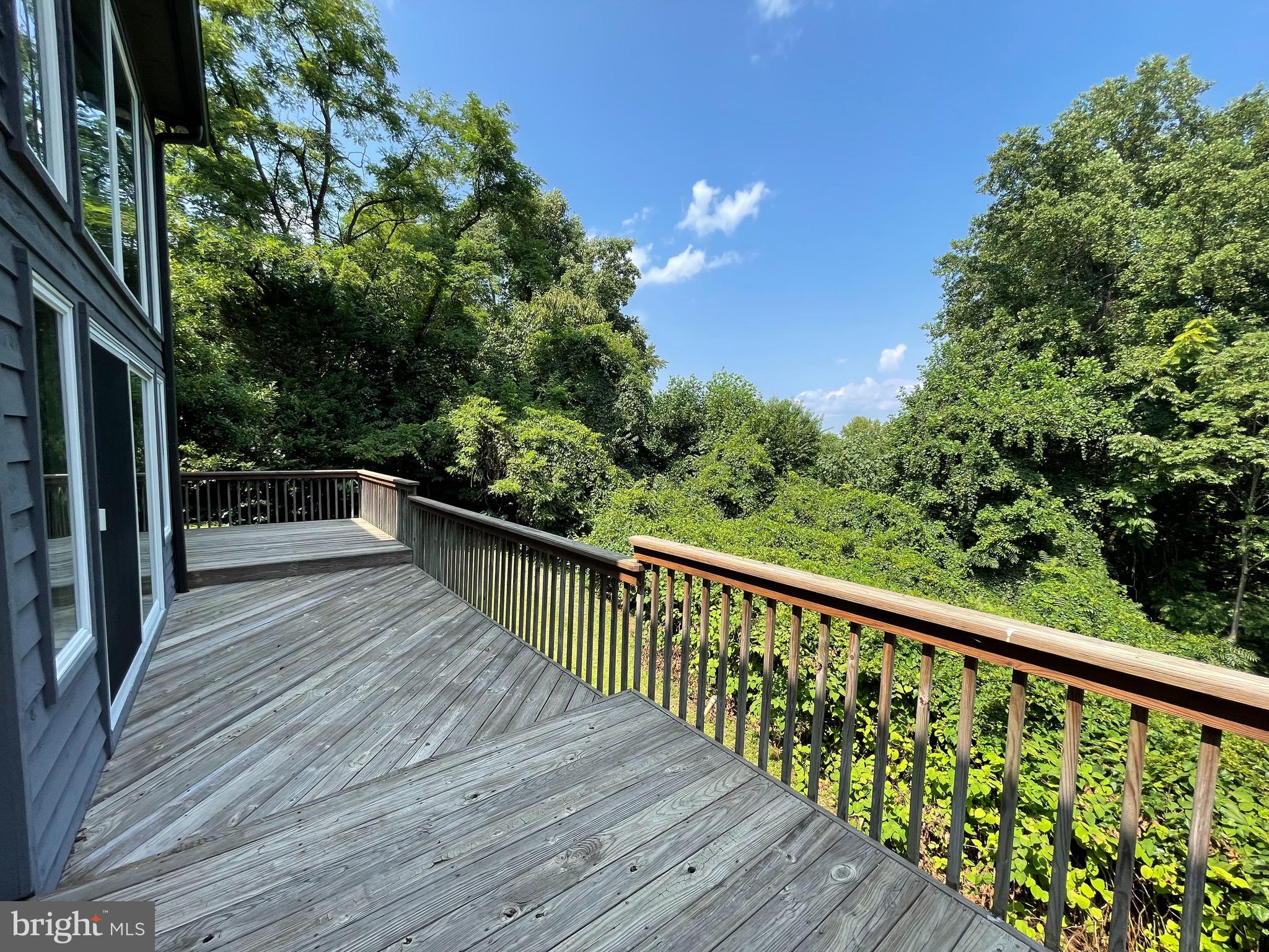 26 Cannon Bluff Drive Stafford, VA 22554 - Photo 13 of 24 a balcony with wooden floor and trees in the back