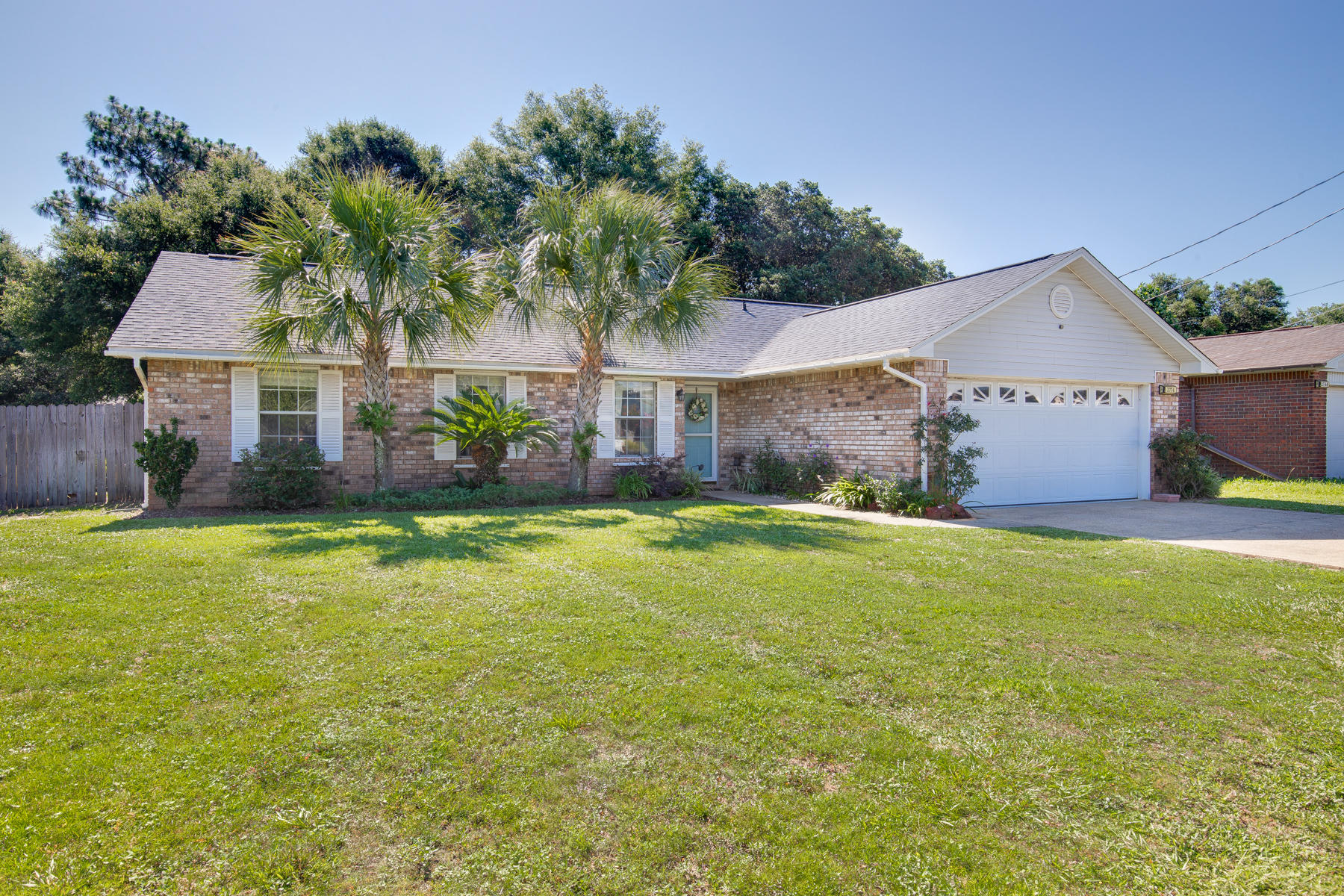 2774 Augustus Road Navarre, FL 32566 - Photo 1 of 18 a front view of house with yard and outdoor seating