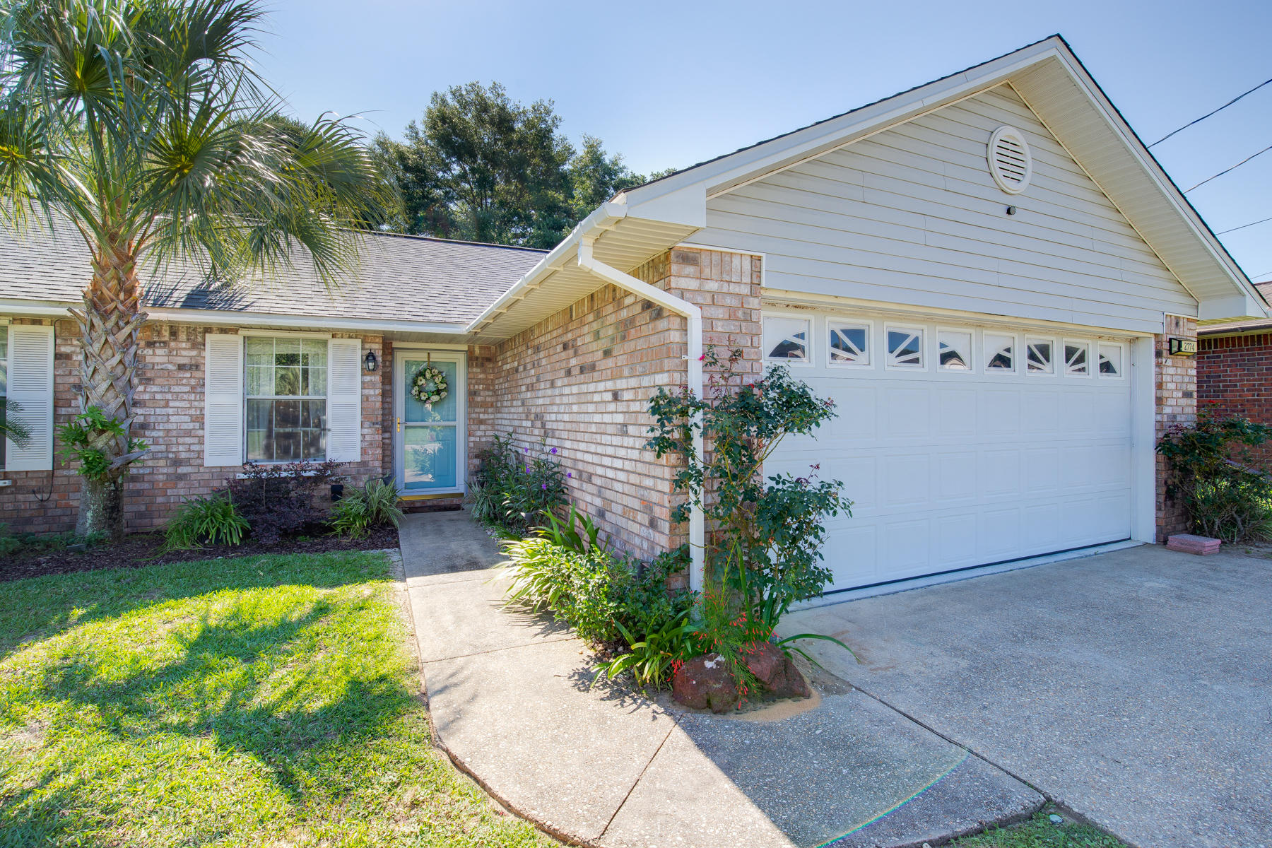2774 Augustus Road Navarre, FL 32566 - Photo 2 of 18 a view of a house with a yard and plants