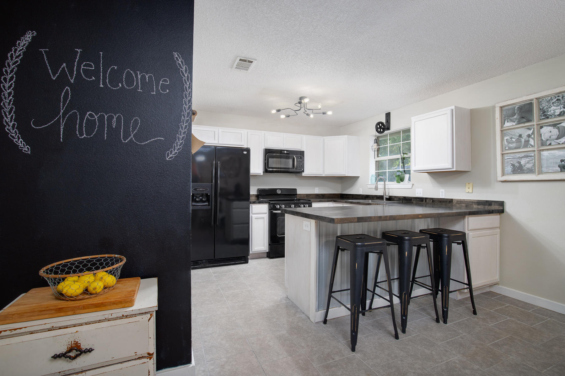 2774 Augustus Road Navarre, FL 32566 - Photo 7 of 18 a kitchen with a sink cabinets and refrigerator