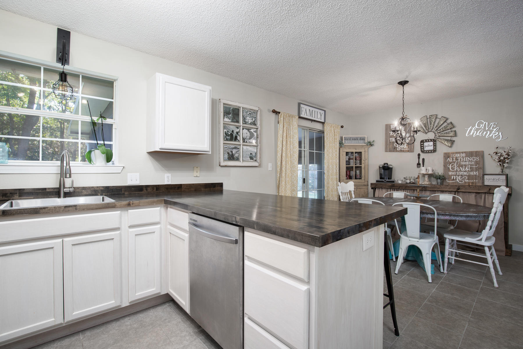 2774 Augustus Road Navarre, FL 32566 - Photo 9 of 18 a kitchen with cabinets and window