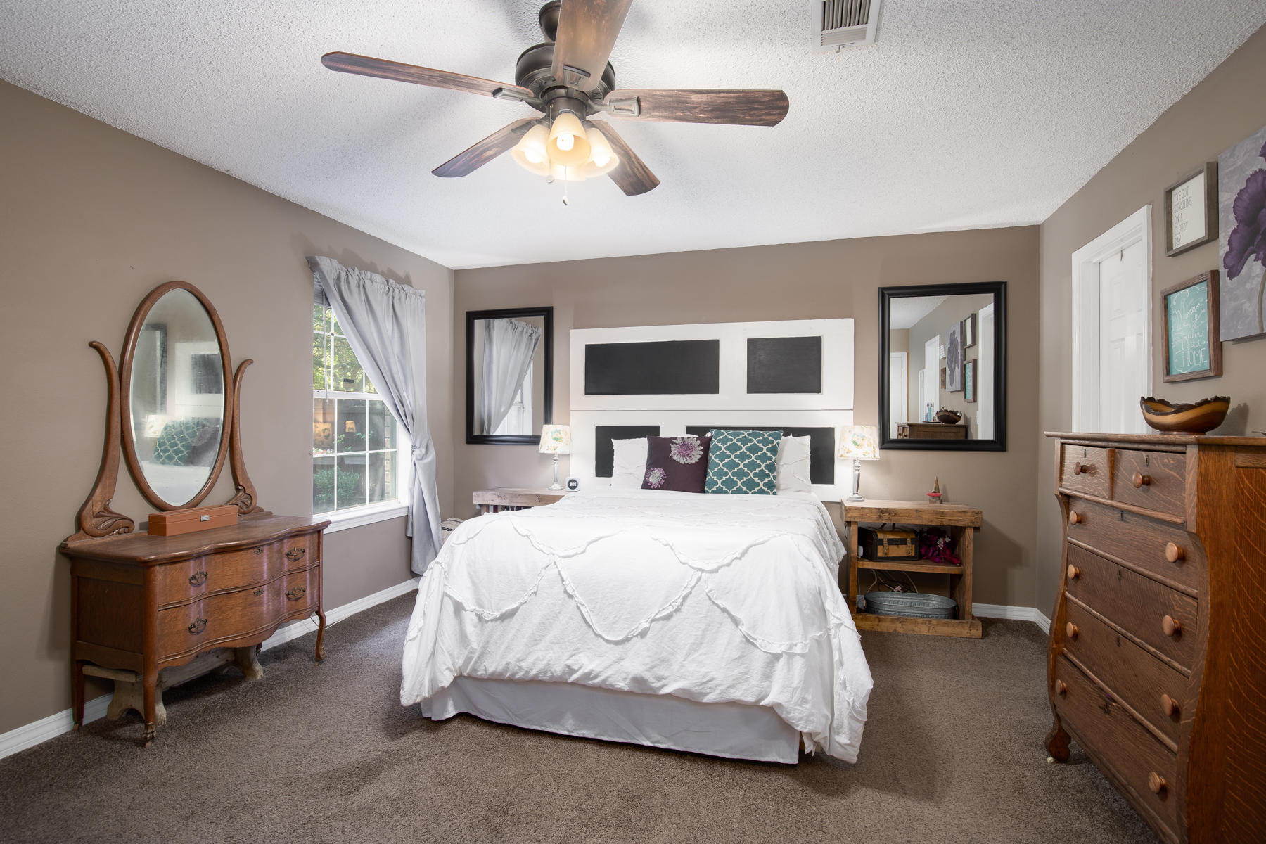 2774 Augustus Road Navarre, FL 32566 - Photo 10 of 18 a bedroom with a bed a dresser next to a window
