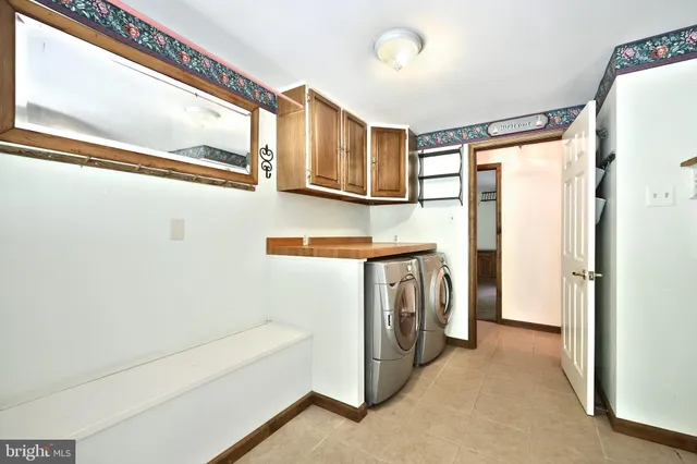 a spacious bathroom with a sink mirror and a bathtub