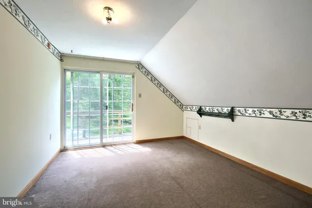 a view of backyard of house with green space and outdoor seating