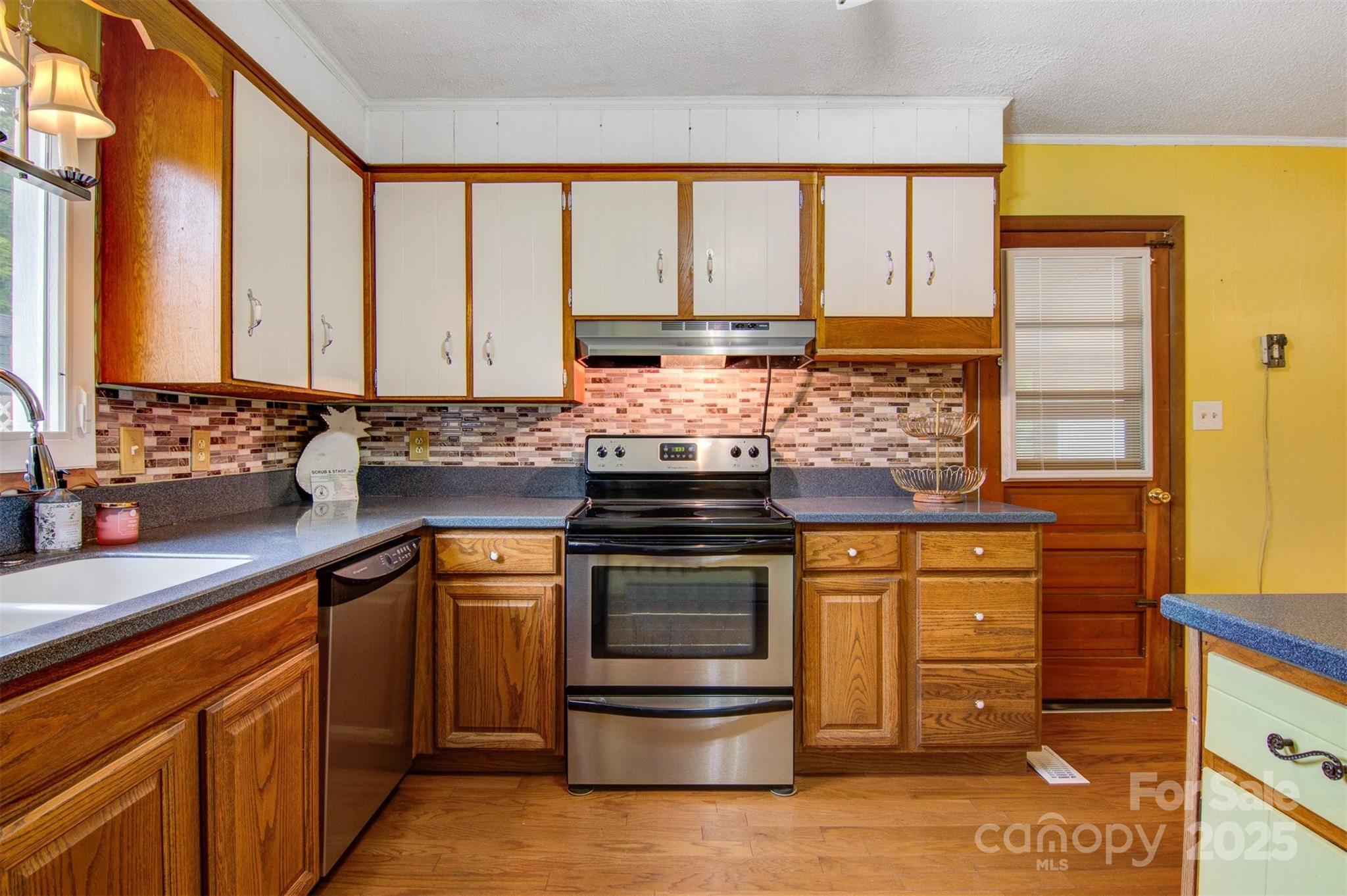 1405 8th Avenue Northwest Conover, NC 28613 - Photo 13 of 41 a kitchen with stainless steel appliances granite countertop a stove and a sink