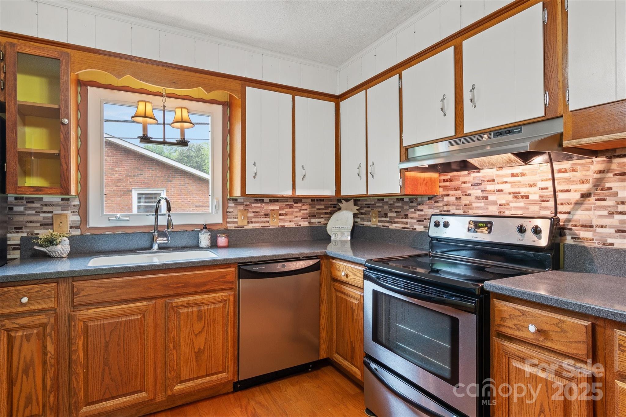 1405 8th Avenue Northwest Conover, NC 28613 - Photo 14 of 41 a kitchen with stainless steel appliances a stove sink and cabinets