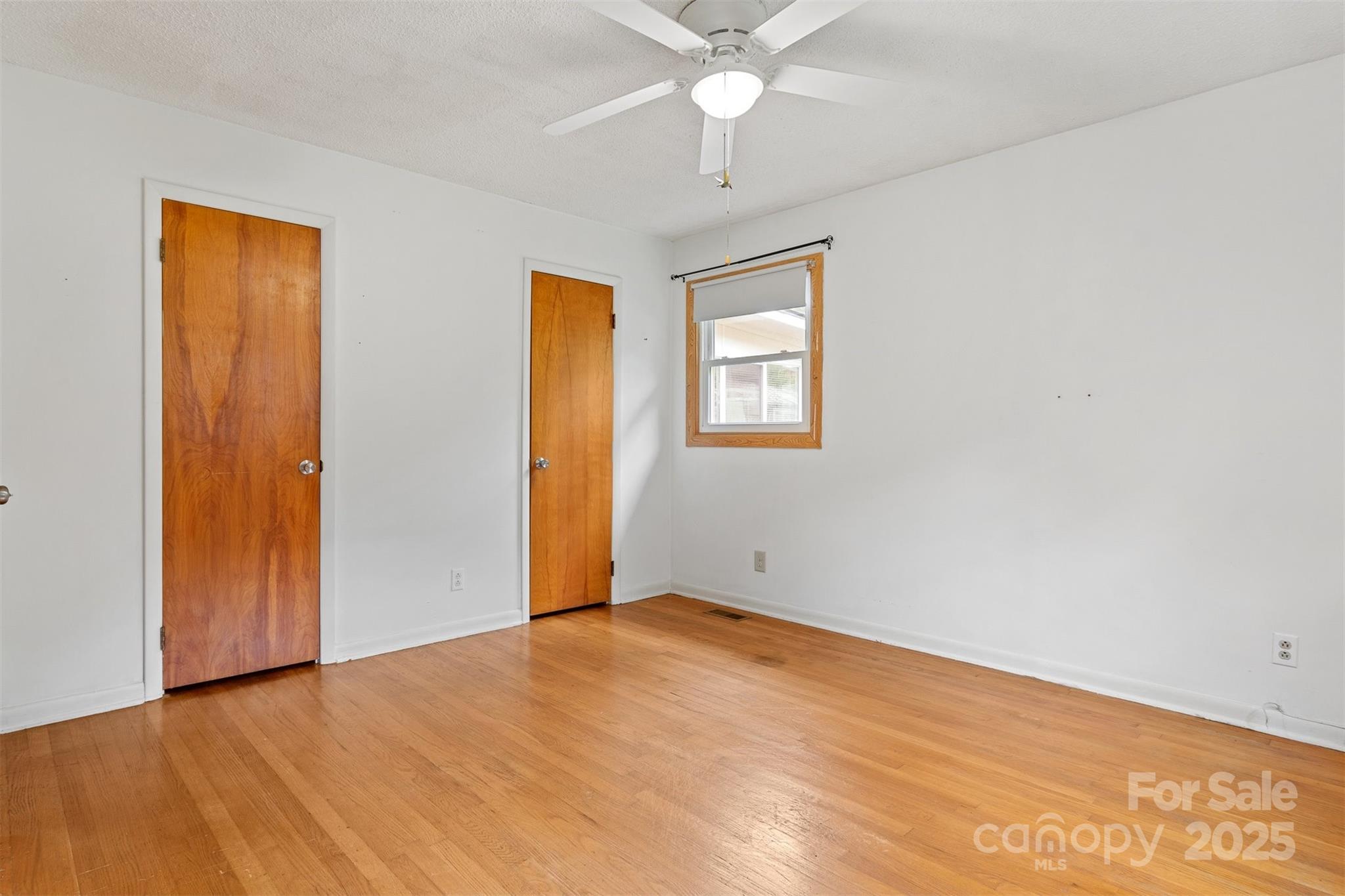 1405 8th Avenue Northwest Conover, NC 28613 - Photo 23 of 41 an empty room with a chandelier fan and windows