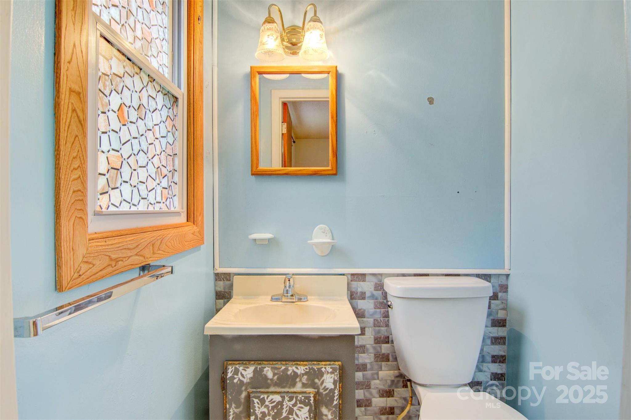 1405 8th Avenue Northwest Conover, NC 28613 - Photo 24 of 41 a bathroom with a toilet sink and mirror