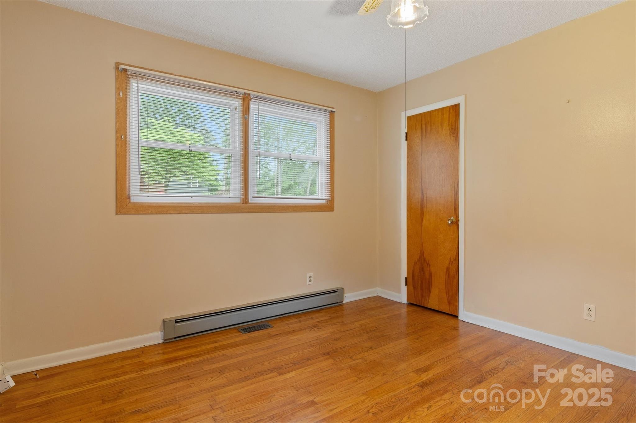 1405 8th Avenue Northwest Conover, NC 28613 - Photo 26 of 41 a view of an empty room with wooden floor and a window
