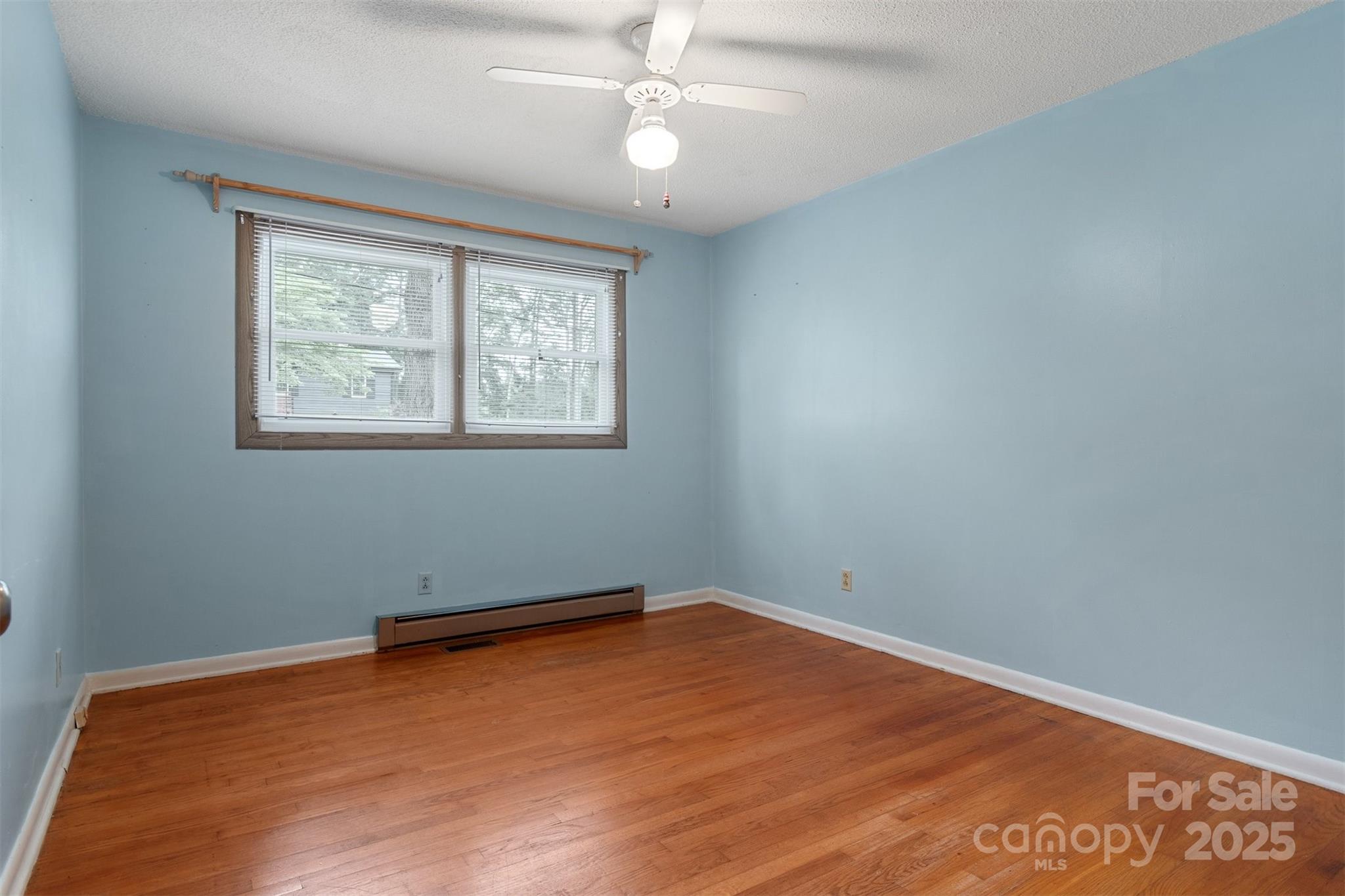 1405 8th Avenue Northwest Conover, NC 28613 - Photo 28 of 41 an empty room with wooden floor and windows