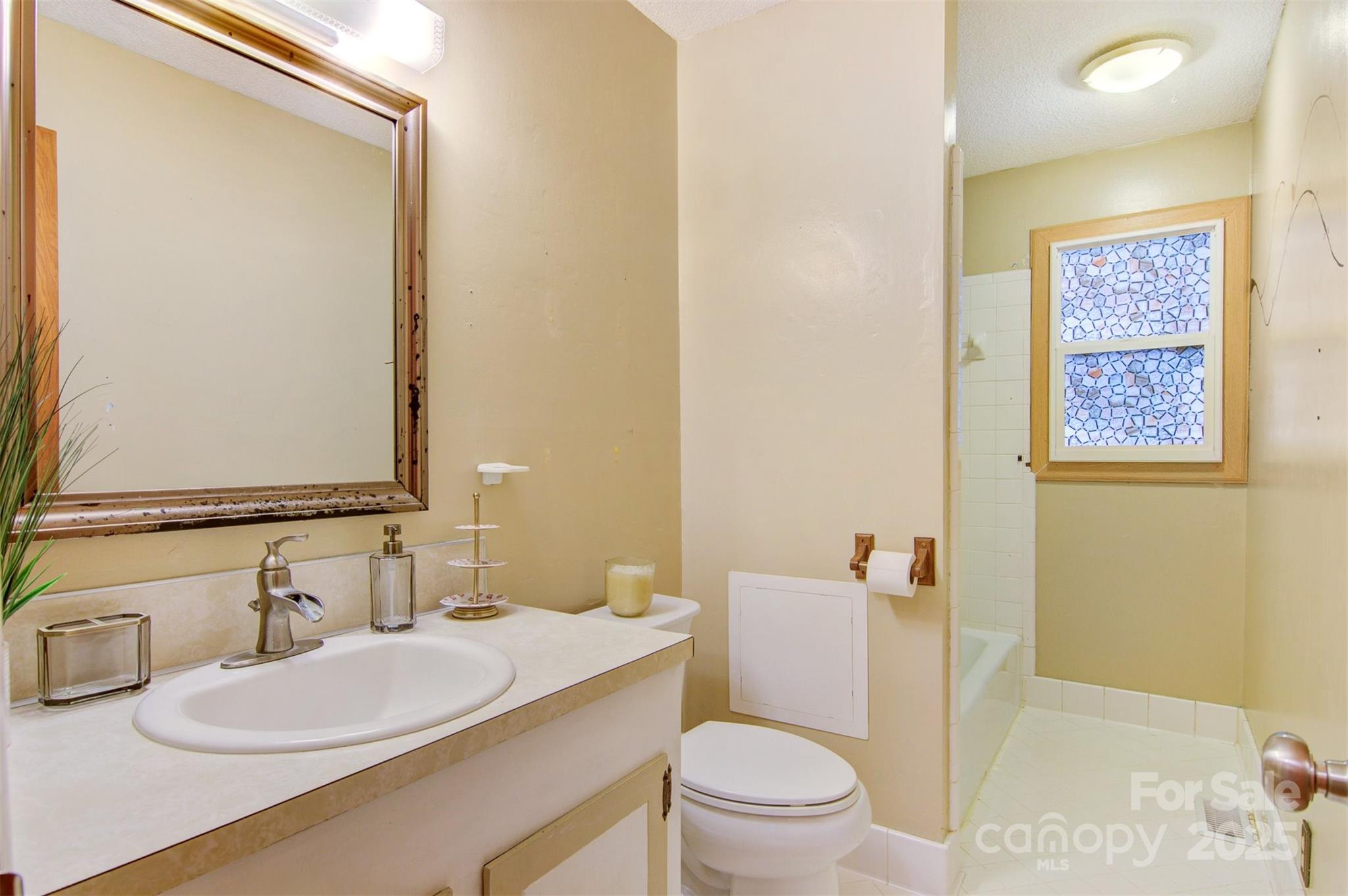 1405 8th Avenue Northwest Conover, NC 28613 - Photo 30 of 41 a bathroom with a granite countertop sink mirror vanity and toilet