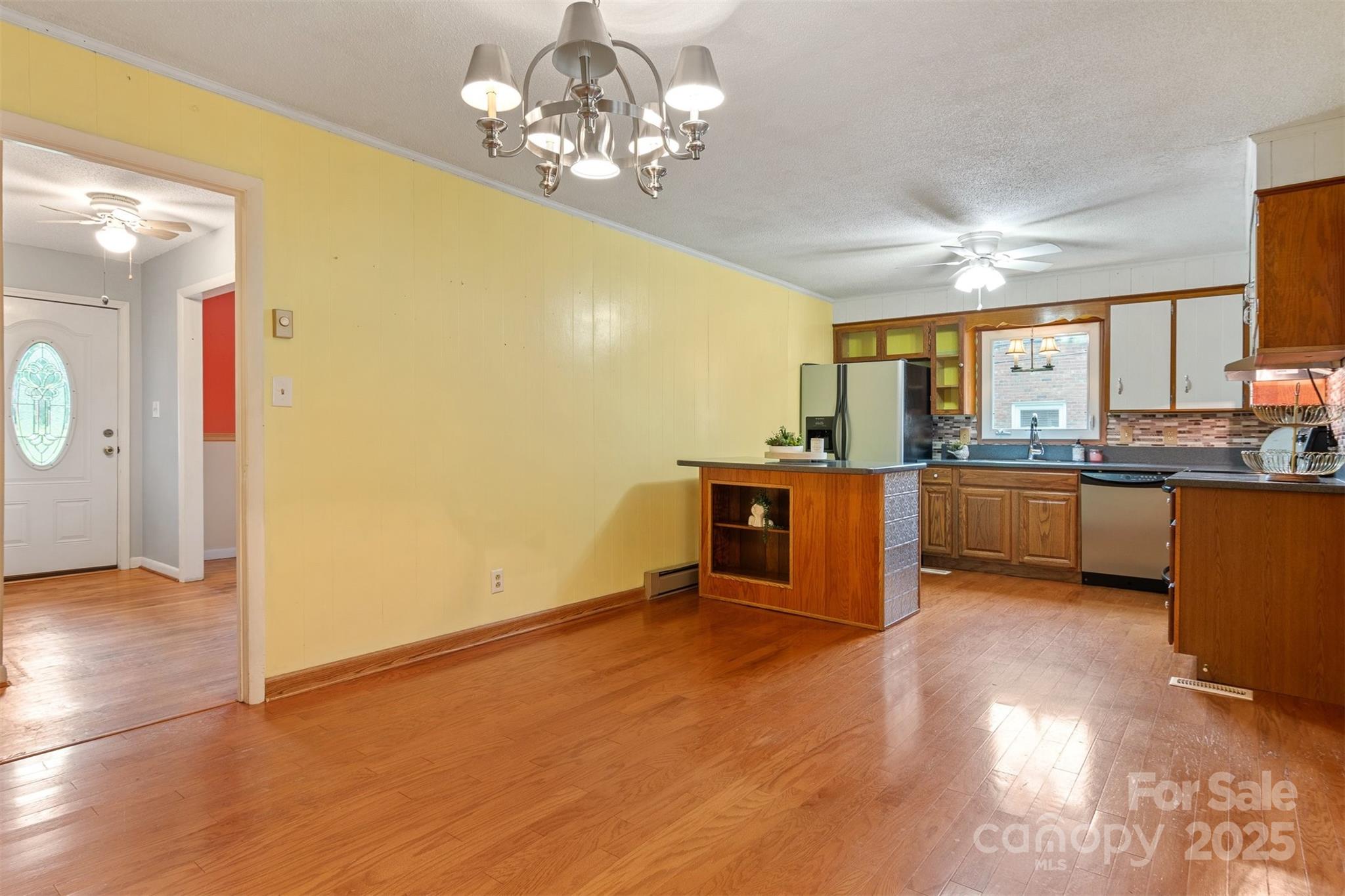 1405 8th Avenue Northwest Conover, NC 28613 - Photo 8 of 41 a view of a kitchen with stainless steel appliances granite countertop a stove top oven a sink dishwasher and cabinets with wooden floor