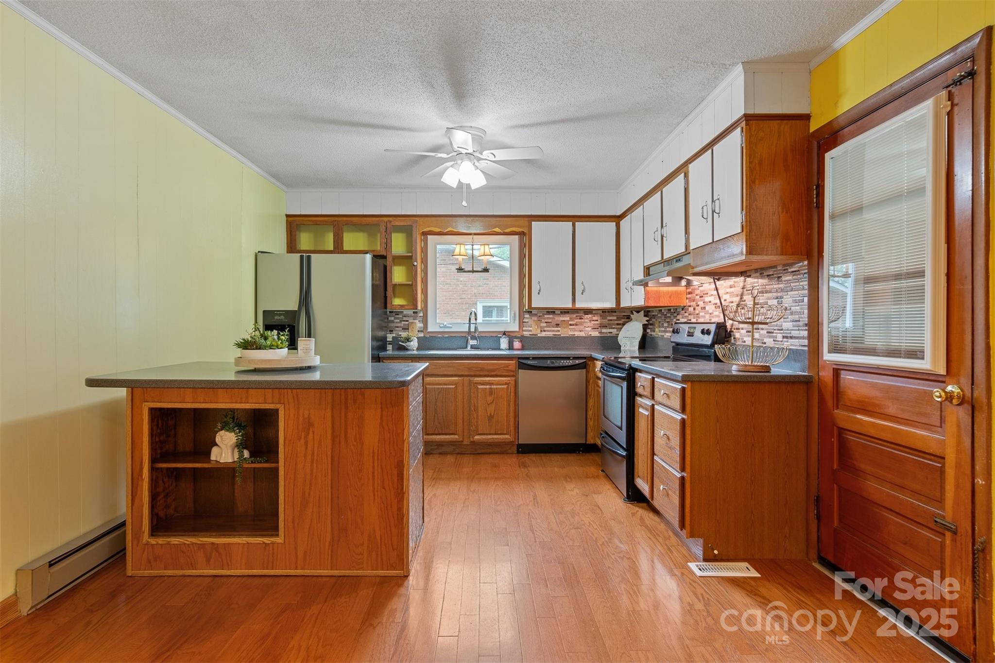 1405 8th Avenue Northwest Conover, NC 28613 - Photo 9 of 41 a kitchen with stainless steel appliances granite countertop a refrigerator a sink dishwasher a stove with wooden cabinets and floor