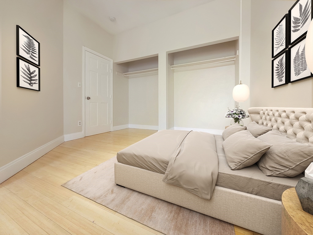 338-342 Warren Street, Unit 3 Boston, MA 02119 - Photo 5 of 7 a bedroom with a bed and a couch