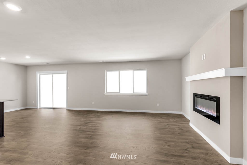308 169th Place Southwest Bothell, WA 98012 - Photo 6 of 20 a view of empty room with wooden floor and fireplace