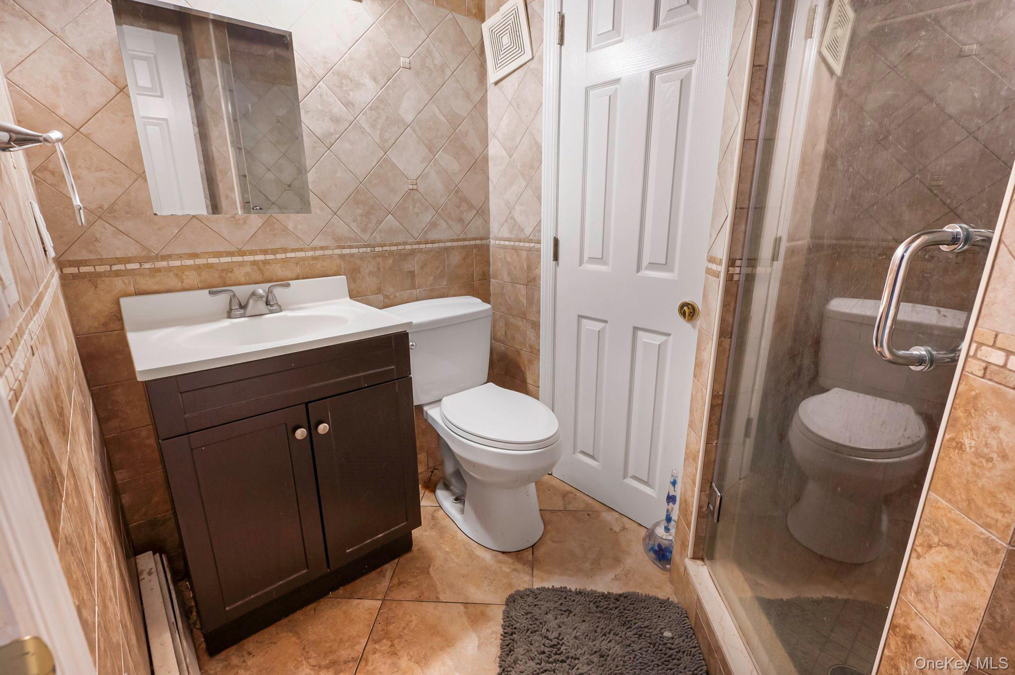 557 Newbridge Road East Meadow, NY 11554 - Photo 16 of 31 a bathroom with a sink toilet and shower