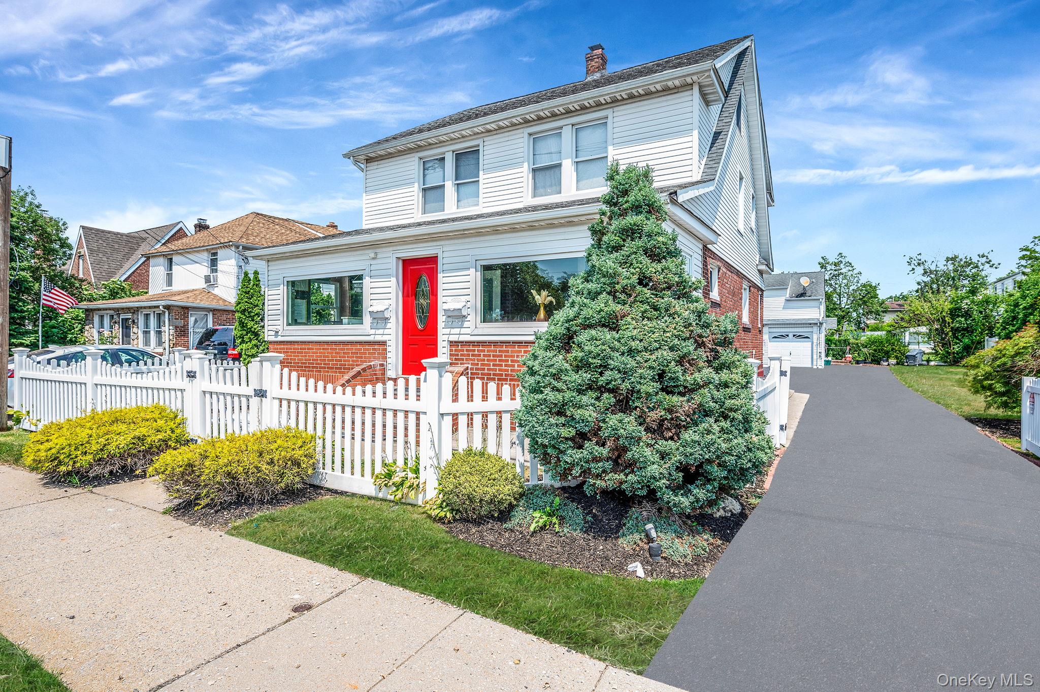 557 Newbridge Road East Meadow, NY 11554 - Photo 2 of 31 a front view of a house with garden