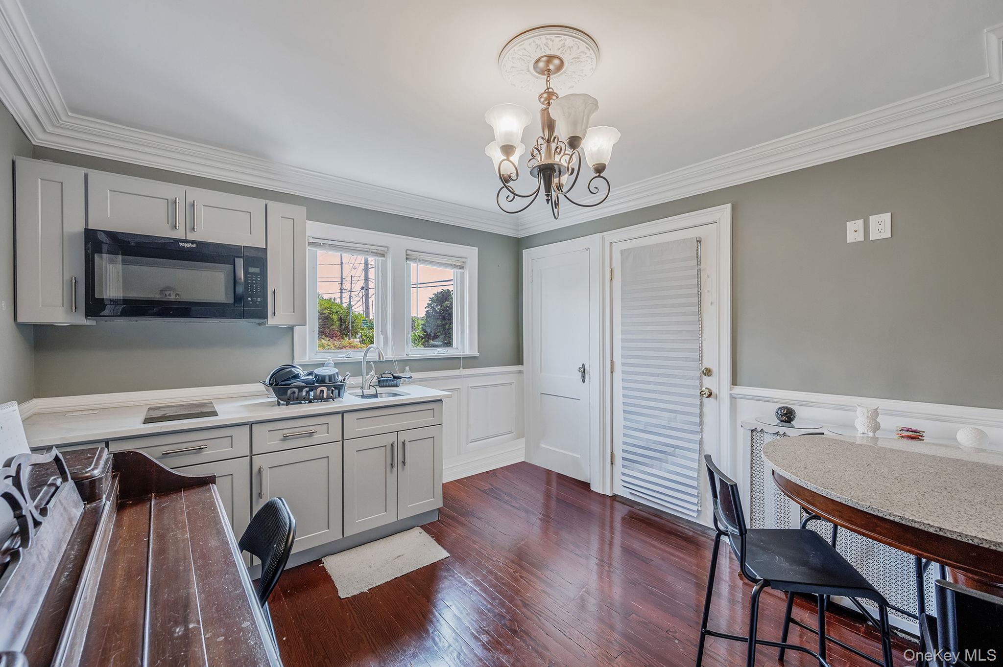 557 Newbridge Road East Meadow, NY 11554 - Photo 24 of 31 a view of a dining room with furniture a livingroom and chandelier