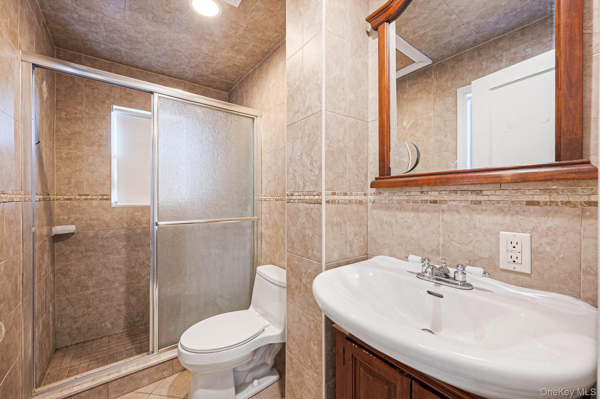 557 Newbridge Road East Meadow, NY 11554 - Photo 26 of 31 a bathroom with a sink toilet and shower