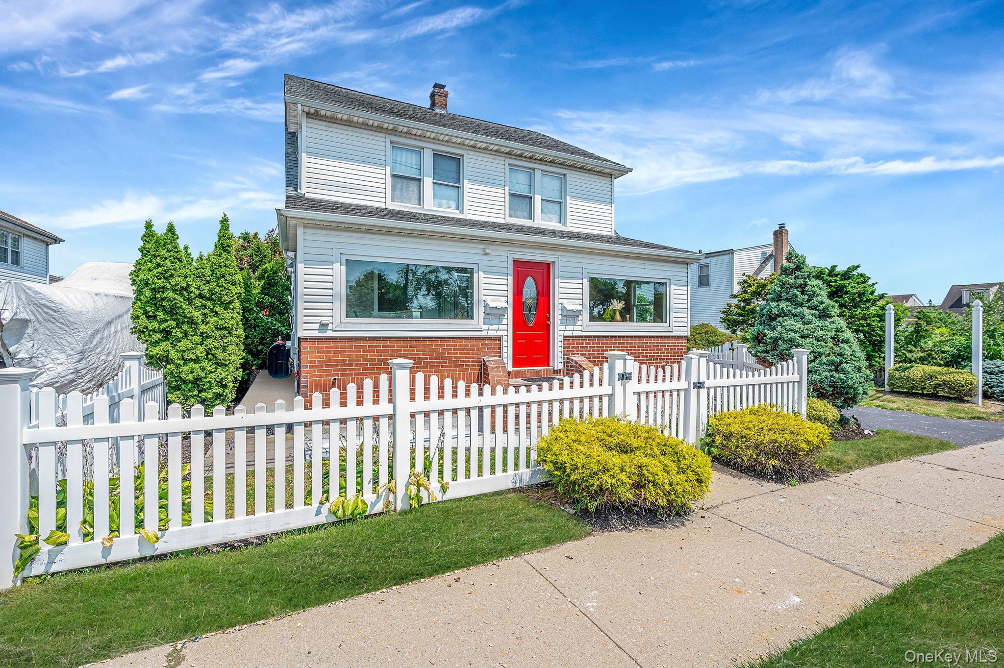 557 Newbridge Road East Meadow, NY 11554 - Photo 3 of 31 a front view of a house with a garden