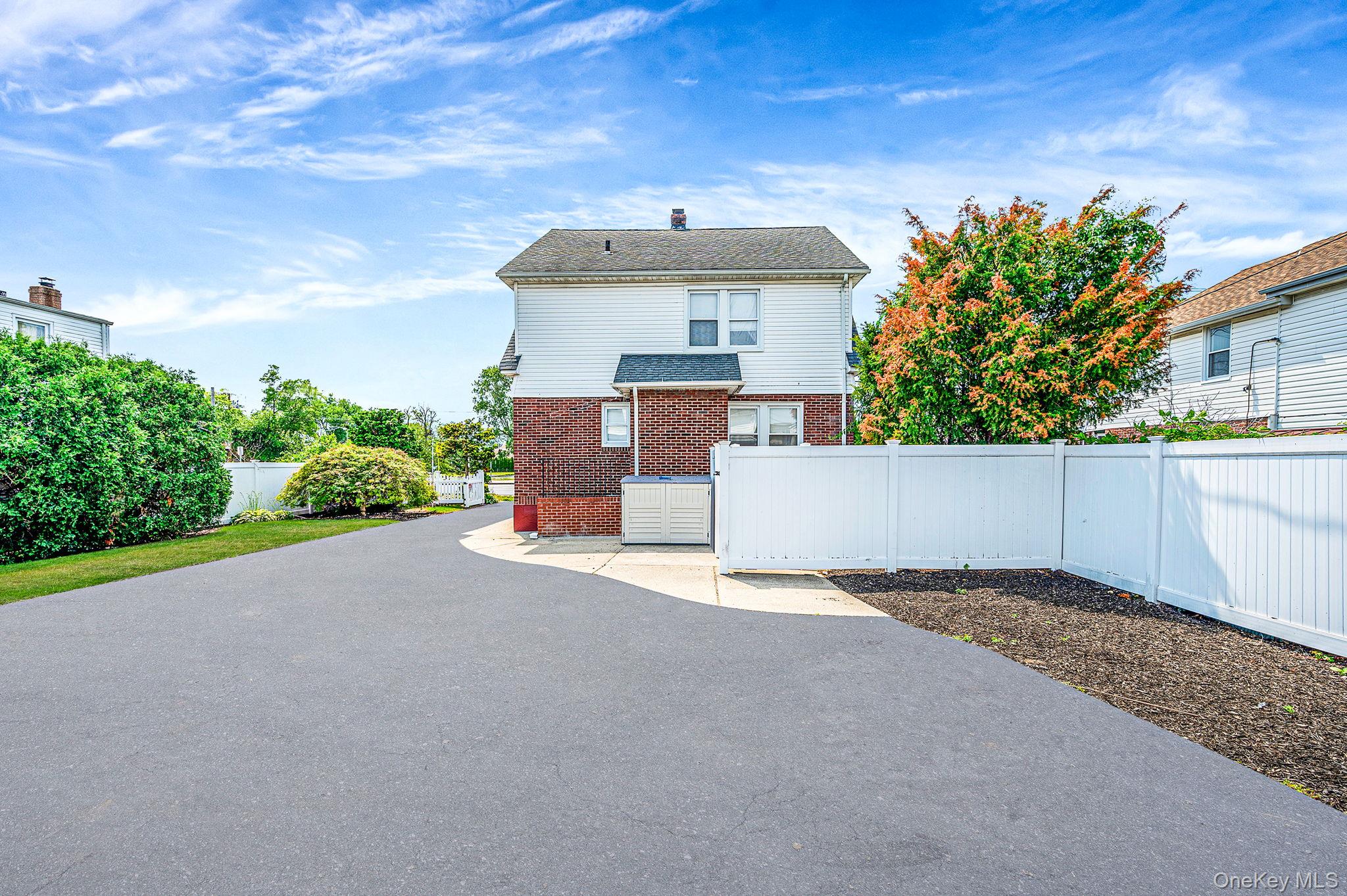 557 Newbridge Road East Meadow, NY 11554 - Photo 5 of 31 a front view of a house with a yard