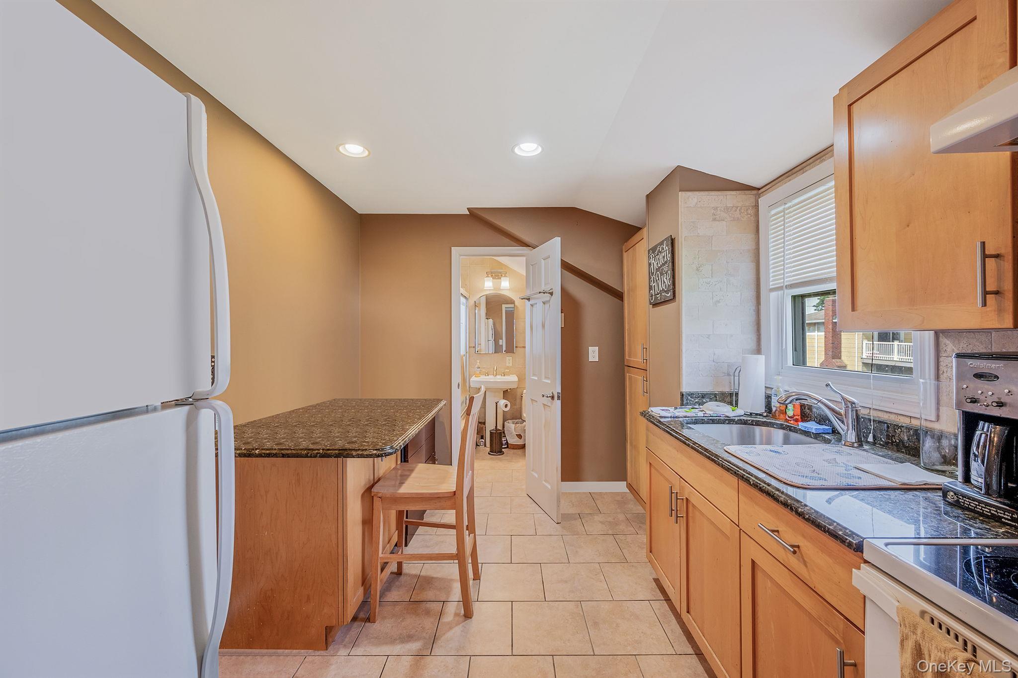 557 Newbridge Road East Meadow, NY 11554 - Photo 8 of 31 a spacious bathroom with a granite countertop sink a mirror and a bathtub