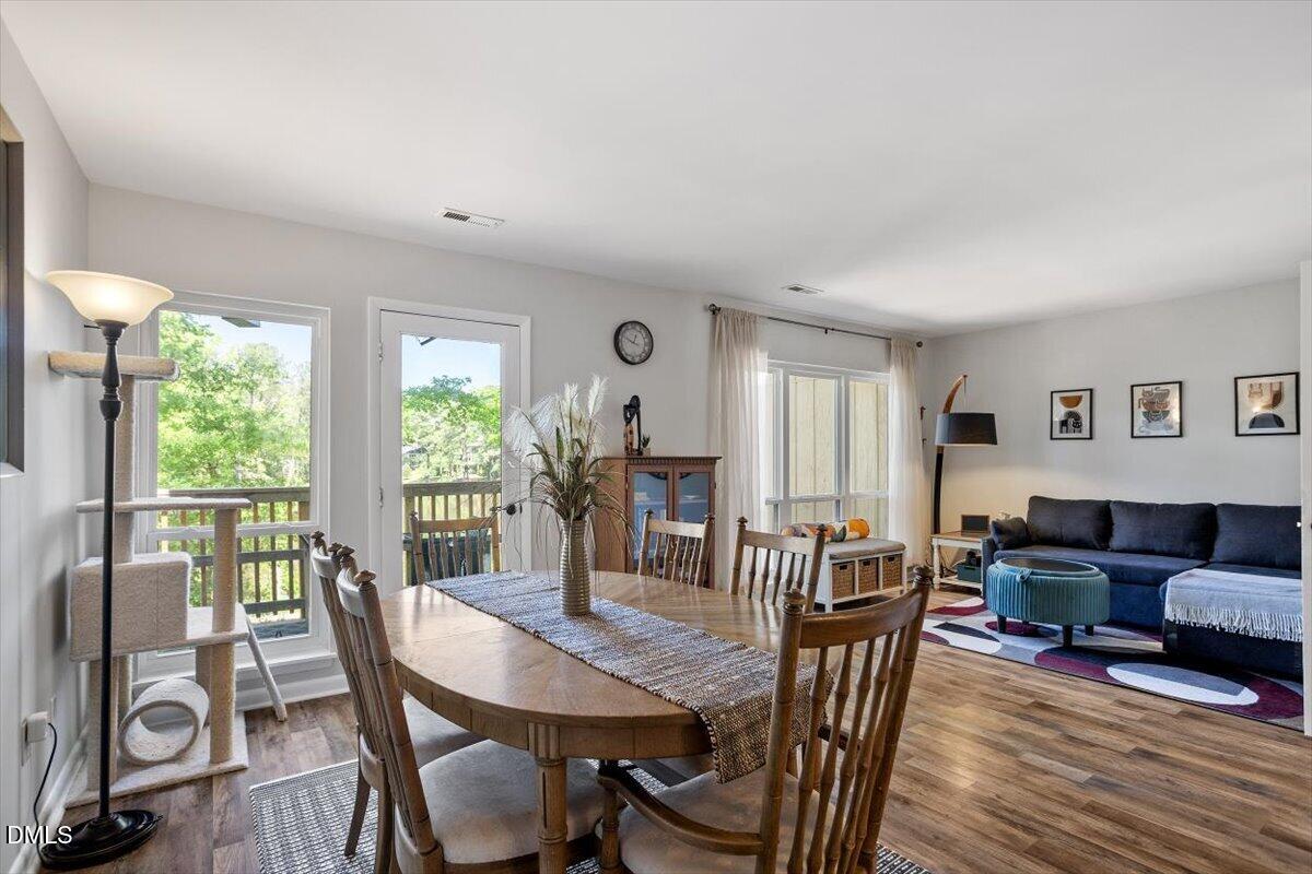 5045 Tall Pines Court Raleigh, NC 27609 - Photo 11 of 37 a view of a dining room with furniture window and wooden floor