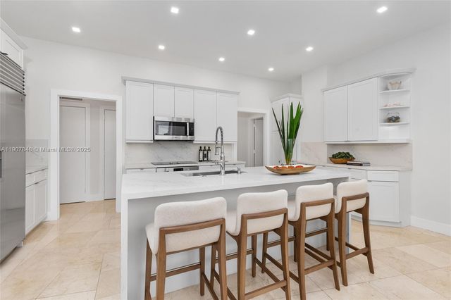 a living room with furniture a potted plant and a rug