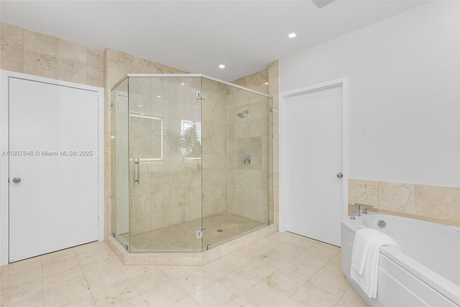 808 Brickell Key Drive, Unit 3901 Miami, FL 33131 - Photo 25 of 72 a bathroom with a shower and a bath tub