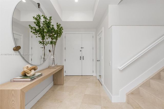 a view of living room filled with furniture and flower pot