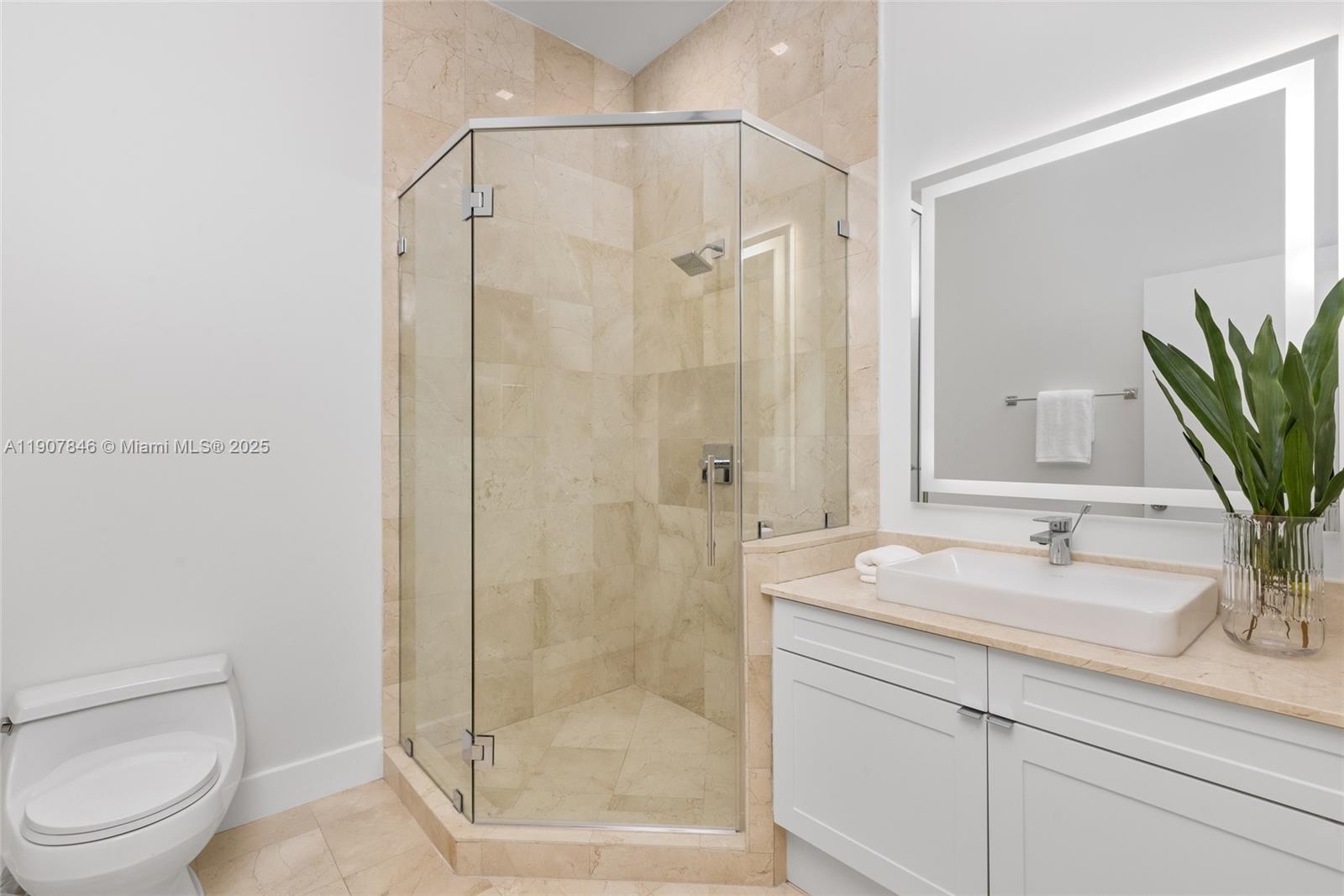 808 Brickell Key Drive, Unit 3901 Miami, FL 33131 - Photo 38 of 72 a bathroom with a shower sink vanity mirror and toilet