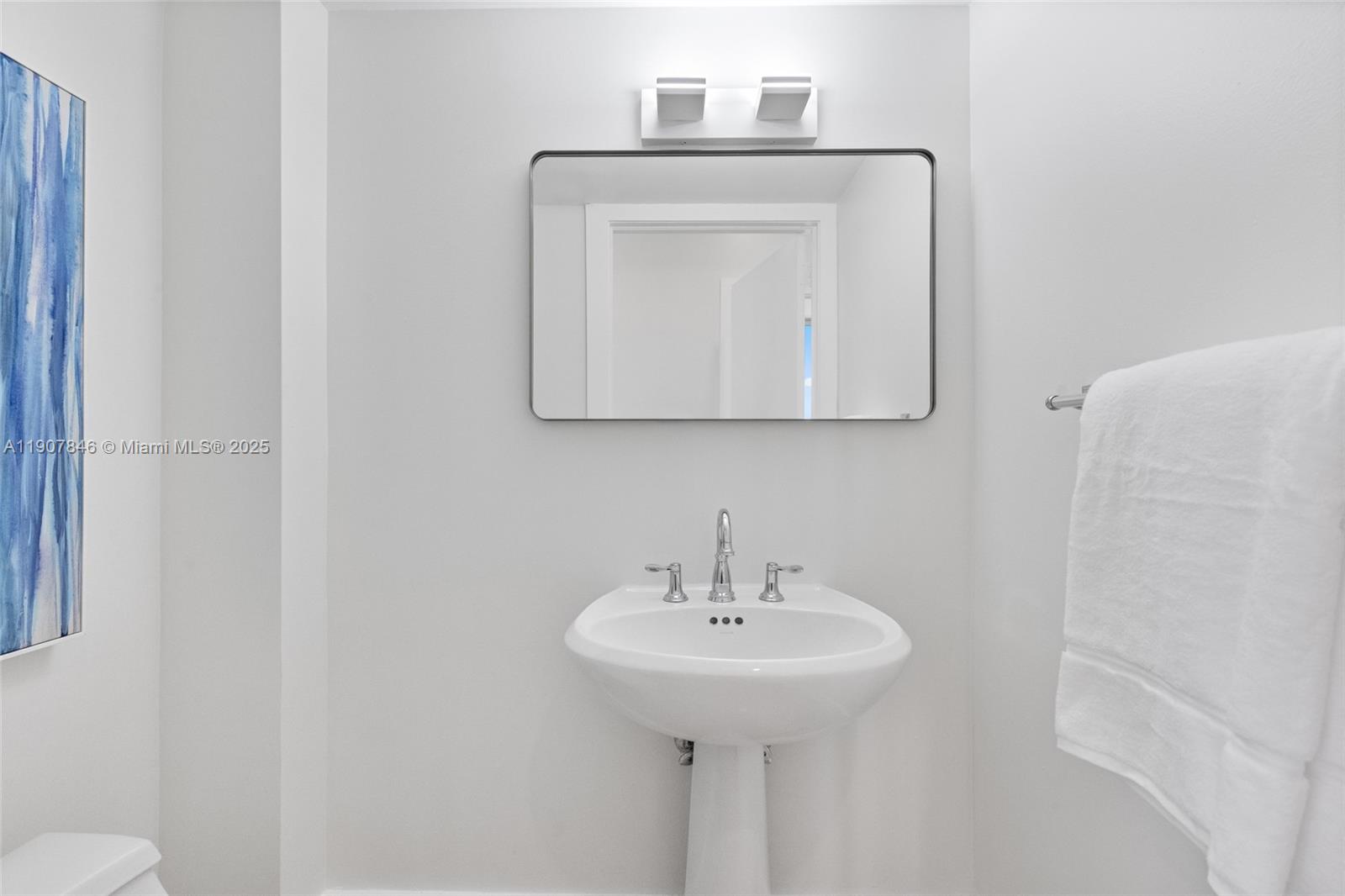 808 Brickell Key Drive, Unit 3901 Miami, FL 33131 - Photo 39 of 72 a bathroom with a sink and a mirror