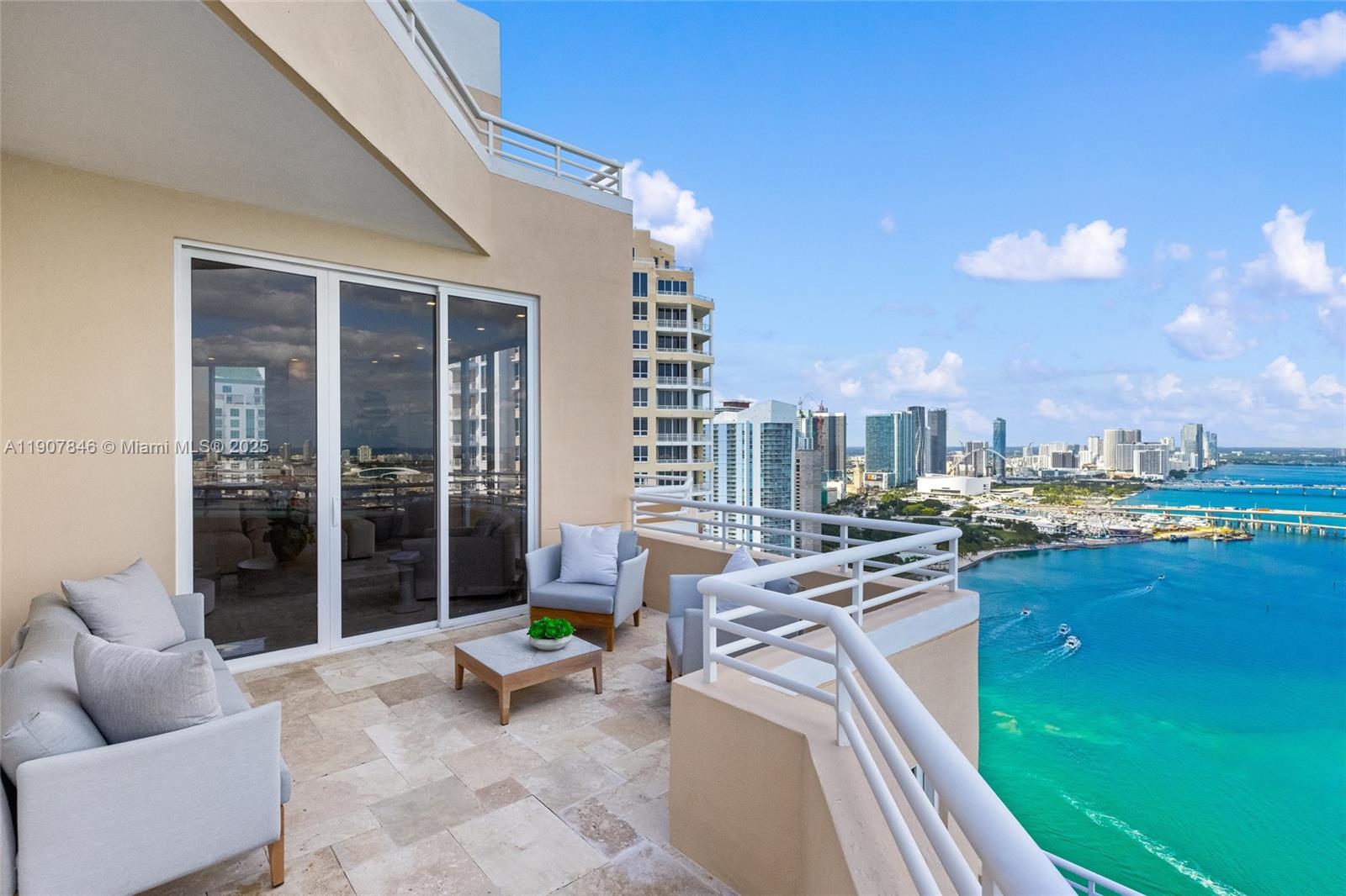 808 Brickell Key Drive, Unit 3901 Miami, FL 33131 - Photo 42 of 72 a view of a patio with swimming pool table and chairs