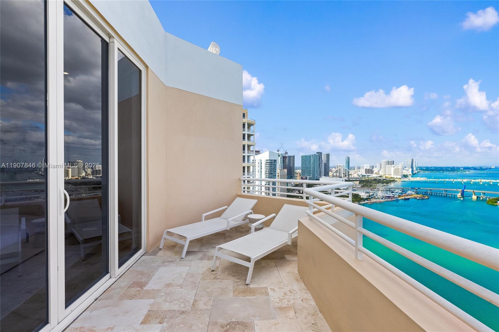 808 Brickell Key Drive, Unit 3901 Miami, FL 33131 - Photo 47 of 72 a building outdoor space with patio furniture and a kitchen view