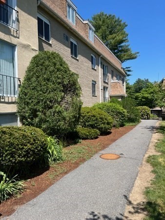 202 Swanson Road, Unit 521 Boxborough, MA 01719 - Photo 14 of 16 a front view of a house with a yard