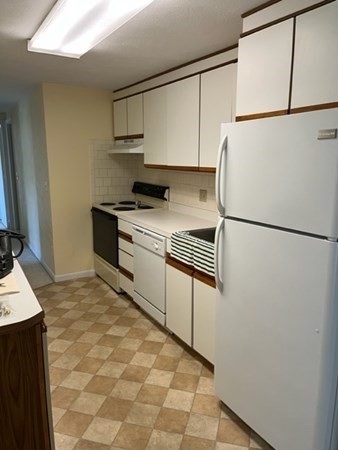 202 Swanson Road, Unit 521 Boxborough, MA 01719 - Photo 4 of 16 a kitchen with stainless steel appliances granite countertop a refrigerator a stove a sink and a granite countertops