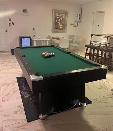 a living room with chairs and table