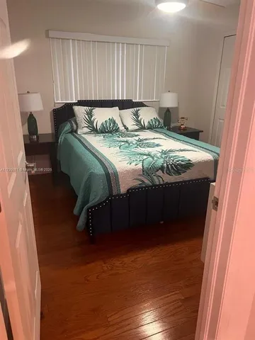 a bed sitting in a bedroom next to a window