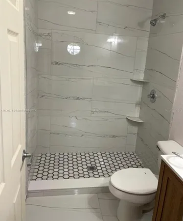 a bathroom with a toilet and a shower