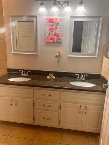 a bathroom with a sink a vanity and a mirror