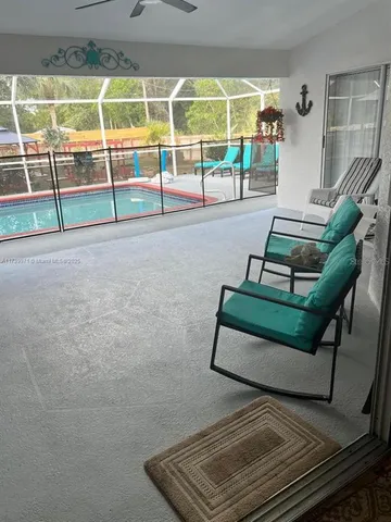 a view of a chairs and table in the backyard
