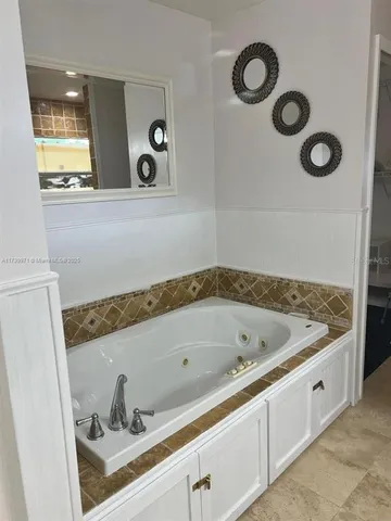 a bathroom with a tub and a sink