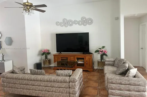 a living room with furniture and a flat screen tv